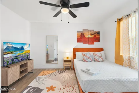 a living room with furniture and a floor to ceiling window