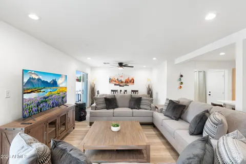 a open kitchen with stainless steel appliances granite countertop a sink a stove and a refrigerator