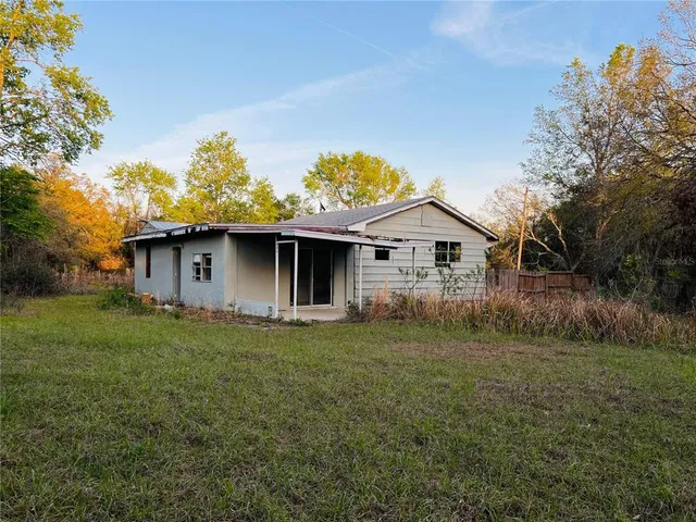 a front view of house with backyard and green space