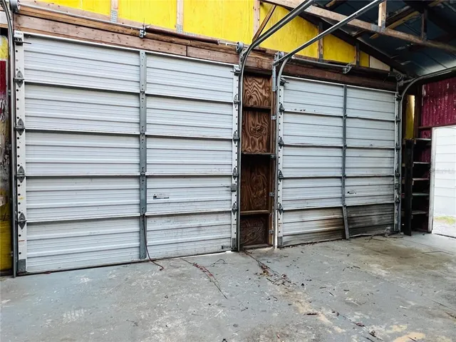 a view of a kitchen with refrigerator and windows
