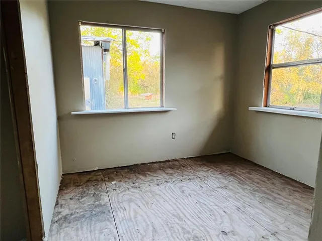a view of a livingroom with an empty space and a window