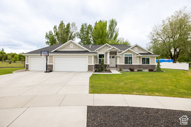 60 East 3880th Street South Logan, UT 84321 - Photo 1 of 1 Craftsman-style home featuring an attached garage, driveway, board and batten siding, and stone siding