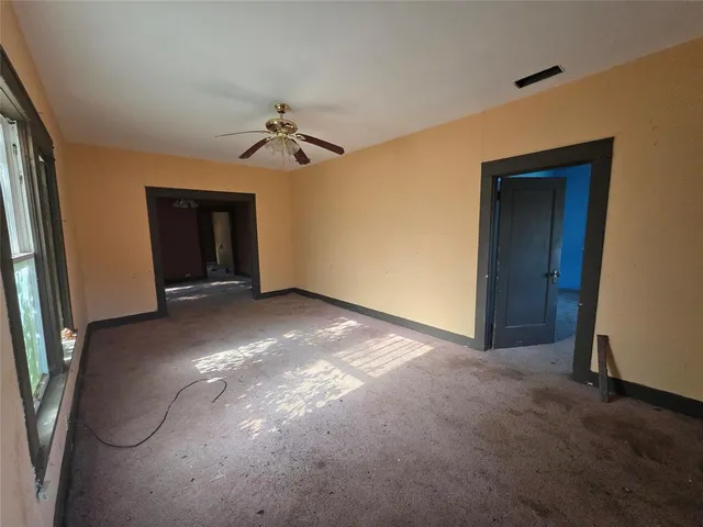 a view of a livingroom with a ceiling fan and window