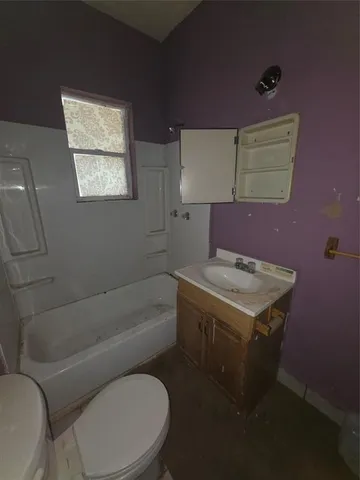 a bathroom with a sink a toilet and bathtub