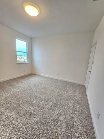 an empty room with a empty space and a window