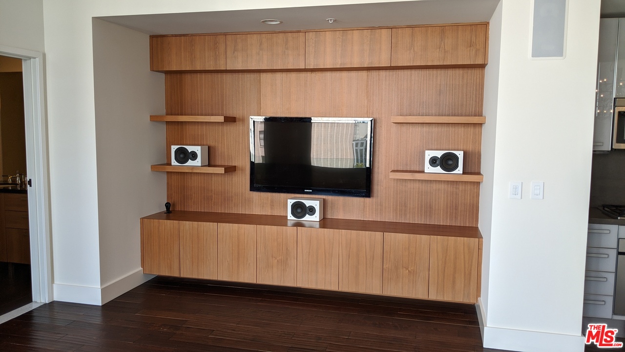 460 South Spring Street, Unit 1005 Los Angeles, CA 90013 - Photo 25 of 46 a room with a flat screen tv and a window