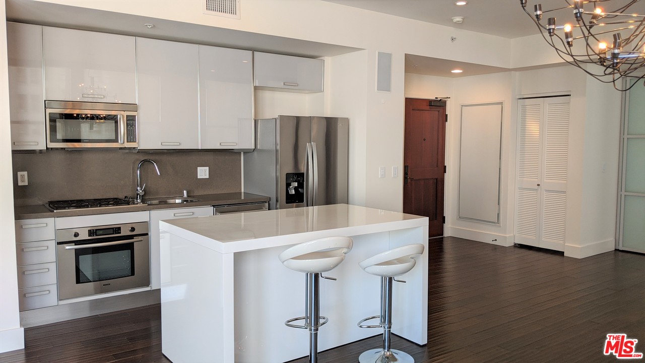 460 South Spring Street, Unit 1005 Los Angeles, CA 90013 - Photo 5 of 46 a kitchen with a sink a stove a microwave and refrigerator