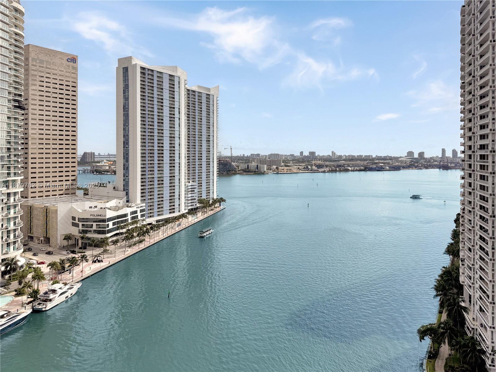 465 Brickell Avenue, Unit 2002 Miami, FL 33131 - Photo 2 of 44 a view of a lake with tall buildings