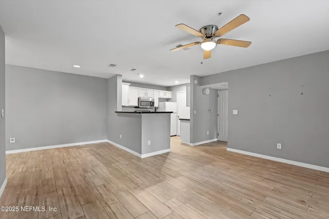 a view of kitchen with wooden floor and window