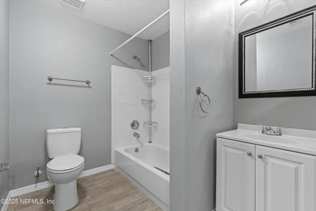 a bathroom with a toilet sink and shower