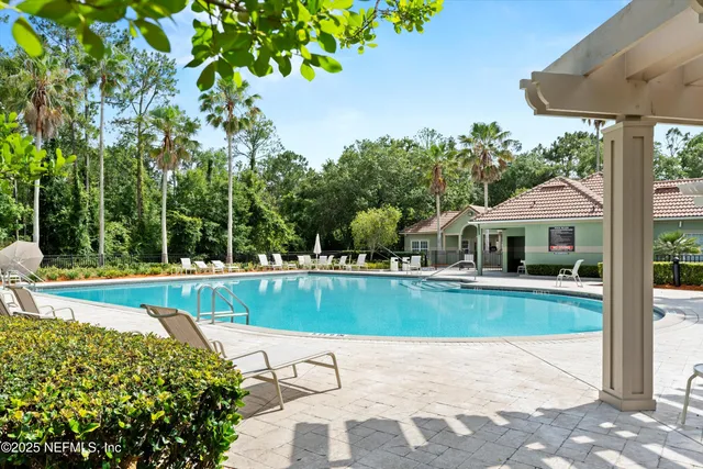 a view of a house with backyard and sitting area