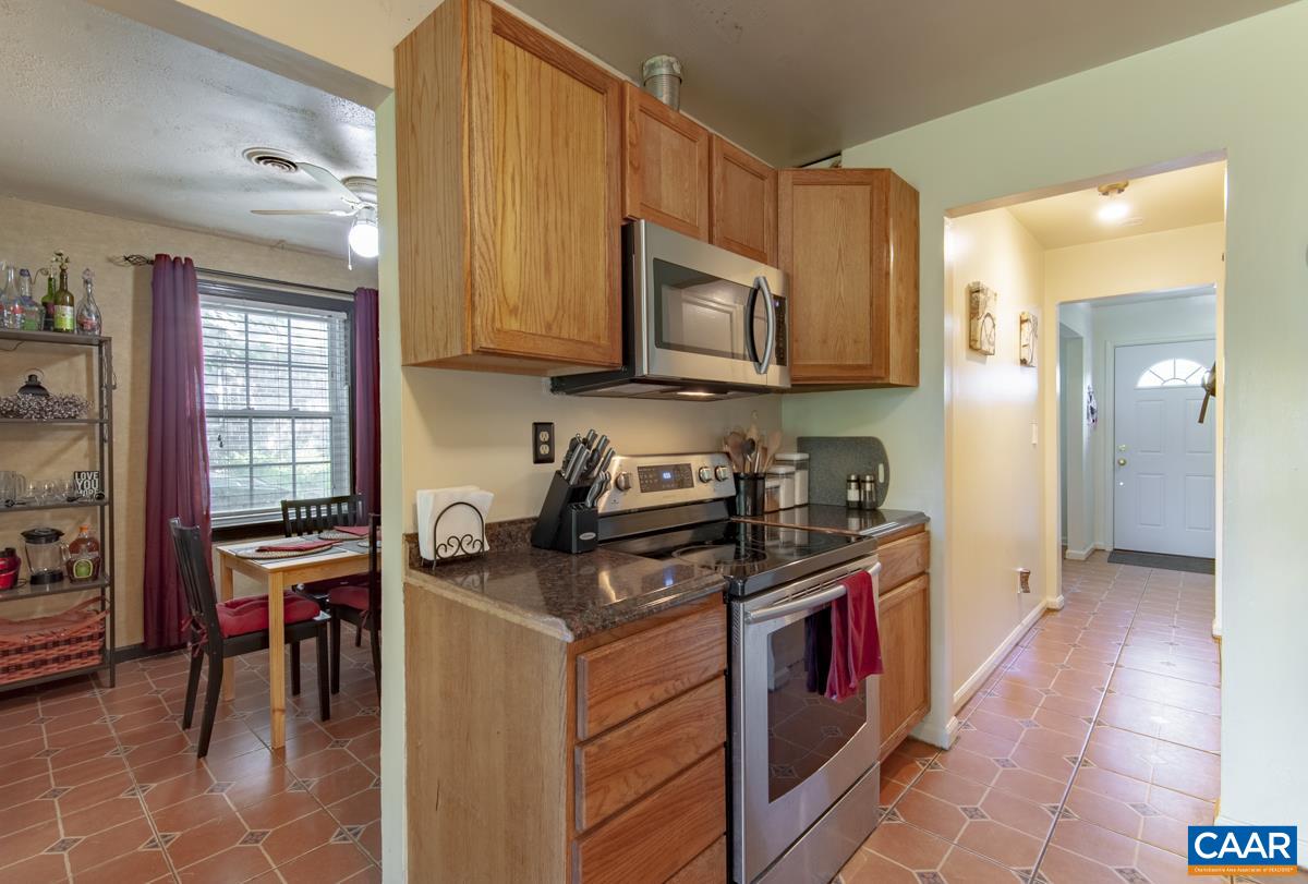 610 Bailey Road Charlottesville, VA 22903 - Photo 11 of 25 a kitchen with stainless steel appliances granite countertop a stove a sink and a microwave