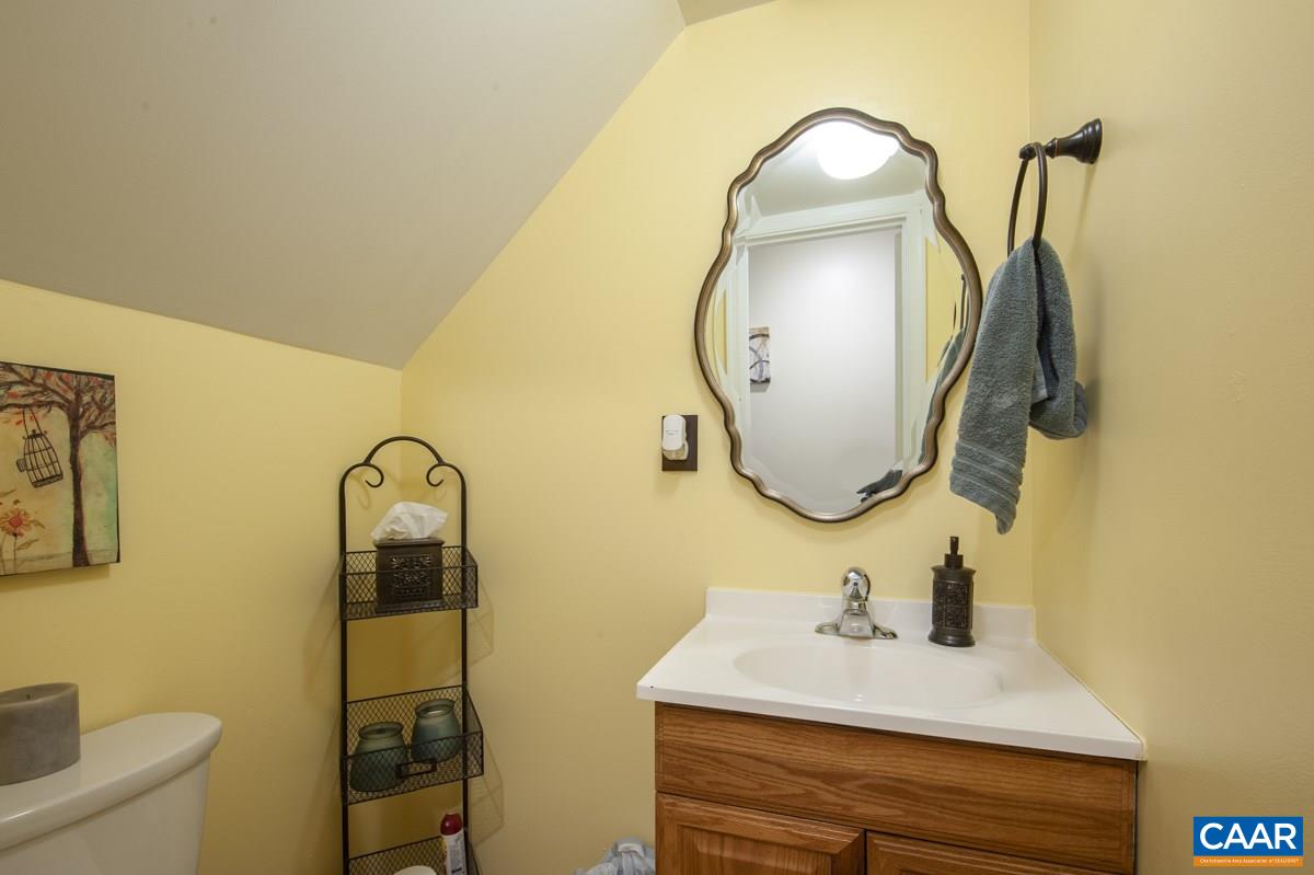 610 Bailey Road Charlottesville, VA 22903 - Photo 14 of 25 a bathroom with a sink mirror and toilet