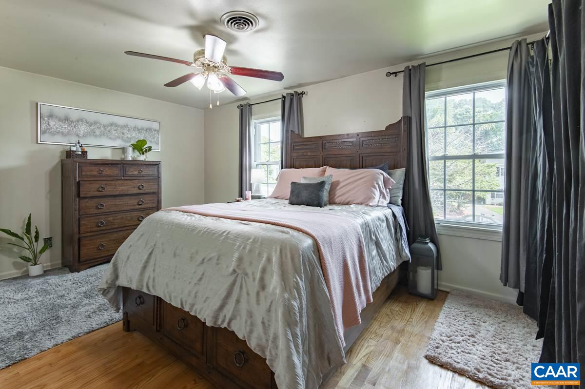 610 Bailey Road Charlottesville, VA 22903 - Photo 15 of 25 a bedroom with a bed and a chandelier
