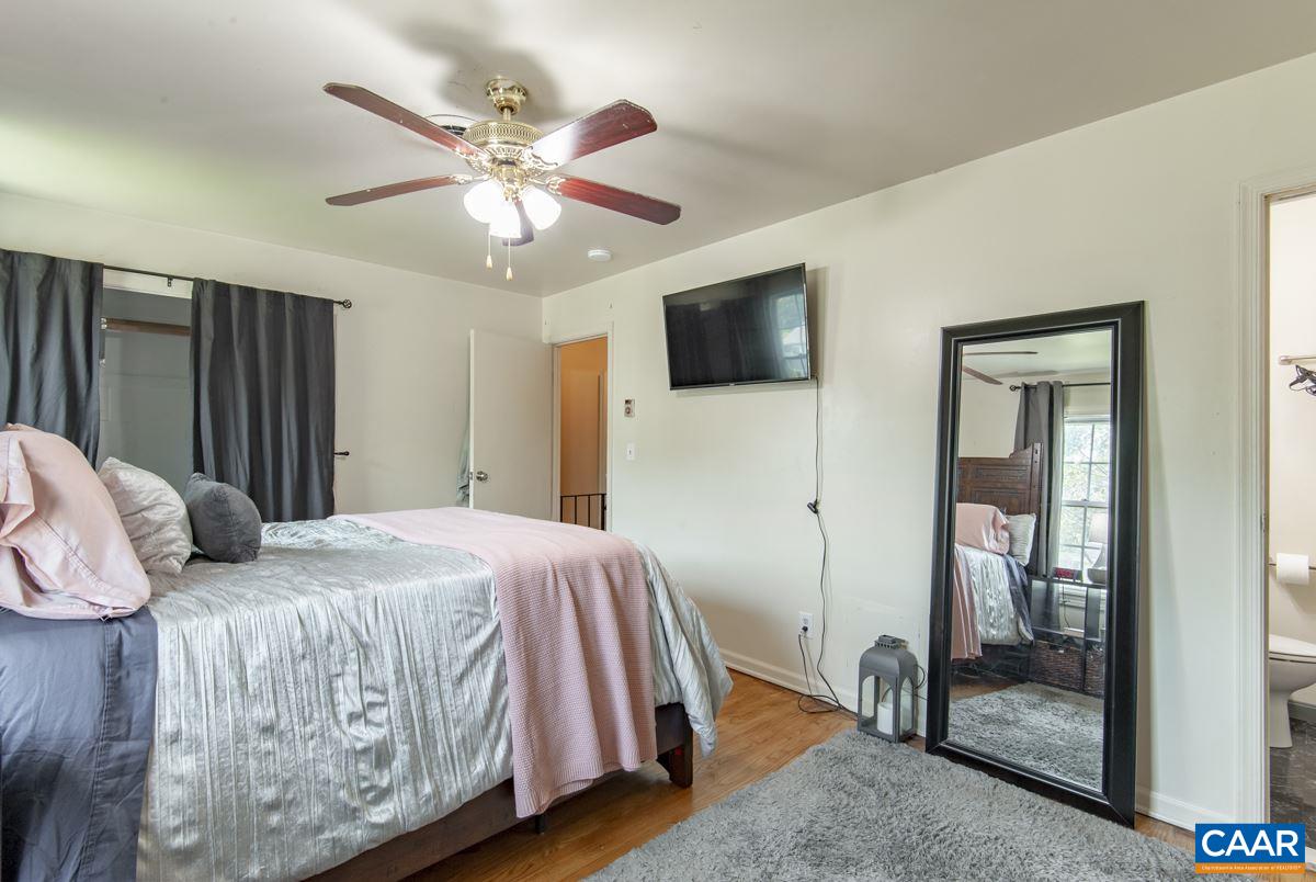 610 Bailey Road Charlottesville, VA 22903 - Photo 16 of 25 a bedroom with a bed and a flat screen tv