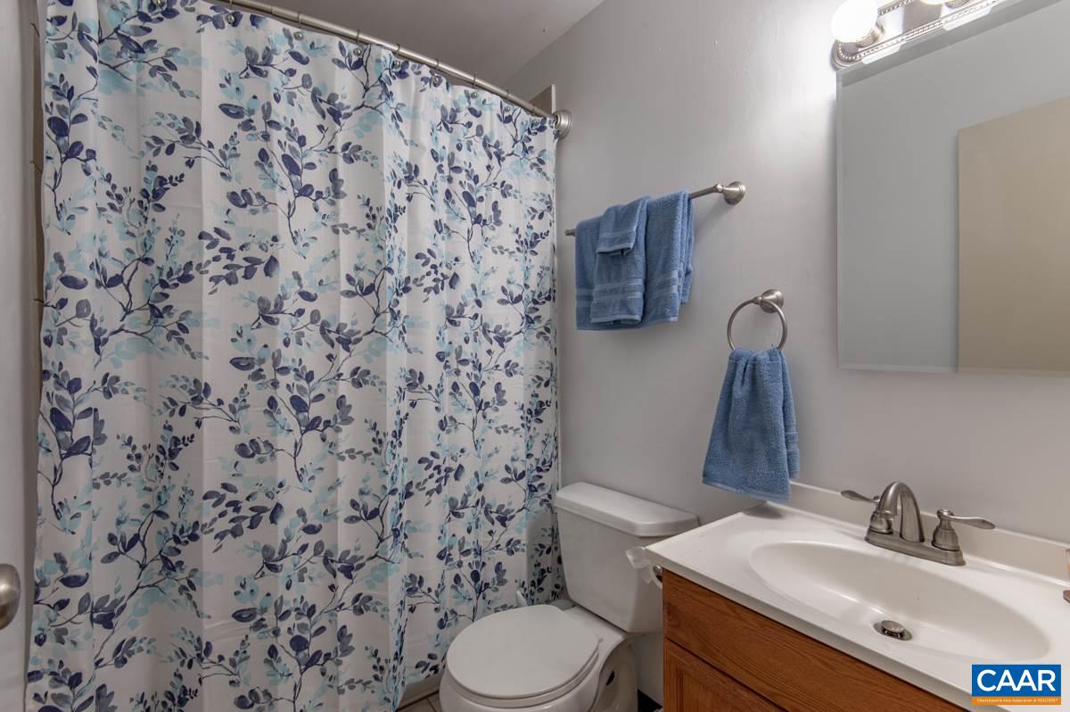 610 Bailey Road Charlottesville, VA 22903 - Photo 20 of 25 a bathroom with a sink toilet and mirror