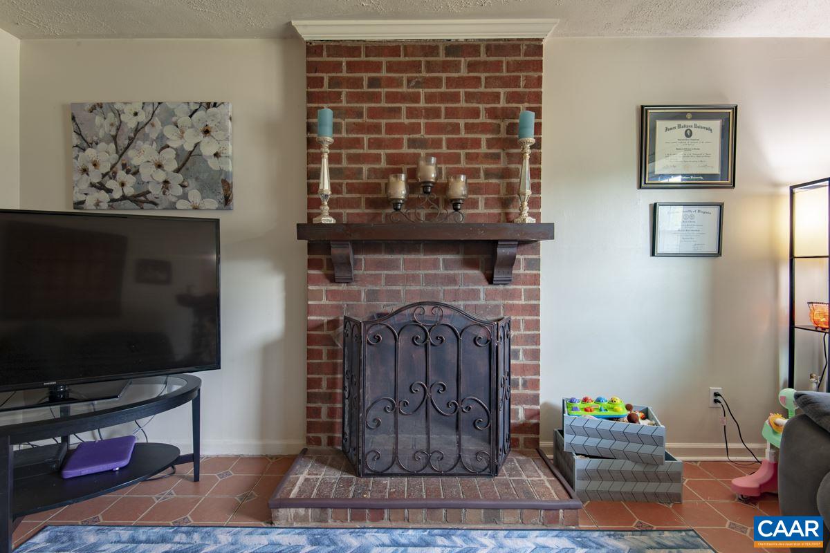 610 Bailey Road Charlottesville, VA 22903 - Photo 5 of 25 a living room with furniture a flat screen tv and a fireplace