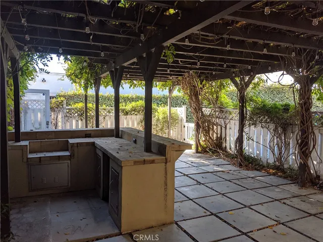 a kitchen with granite countertop a stove a sink and a wooden cabinets