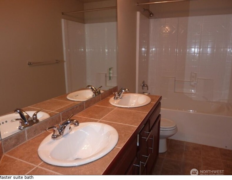 2340 Schley Boulevard Bremerton, WA 98310 - Photo 6 of 9 a bathroom with a sink and a mirror