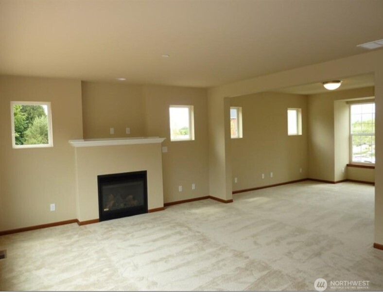 2340 Schley Boulevard Bremerton, WA 98310 - Photo 7 of 9 an empty room with windows and fireplace