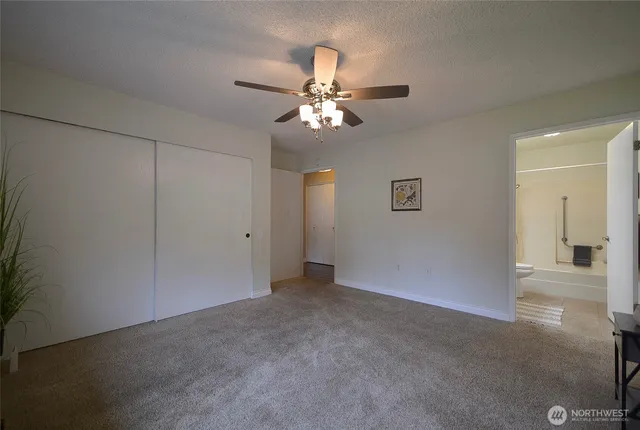 a view of an empty room with a ceiling fan