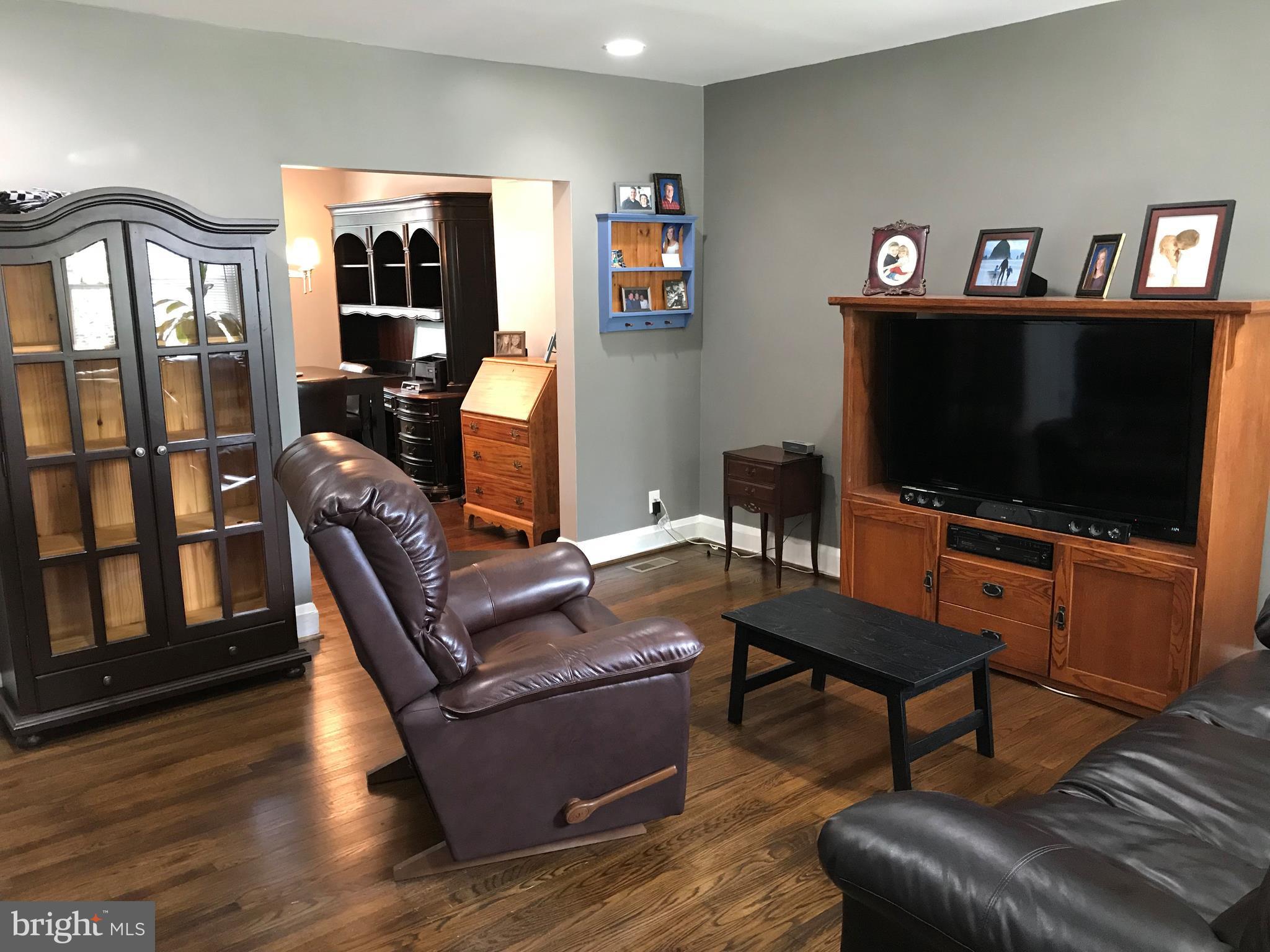 223 Westowne Road Baltimore, MD 21229 - Photo 2 of 21 a living room with furniture and a flat screen tv