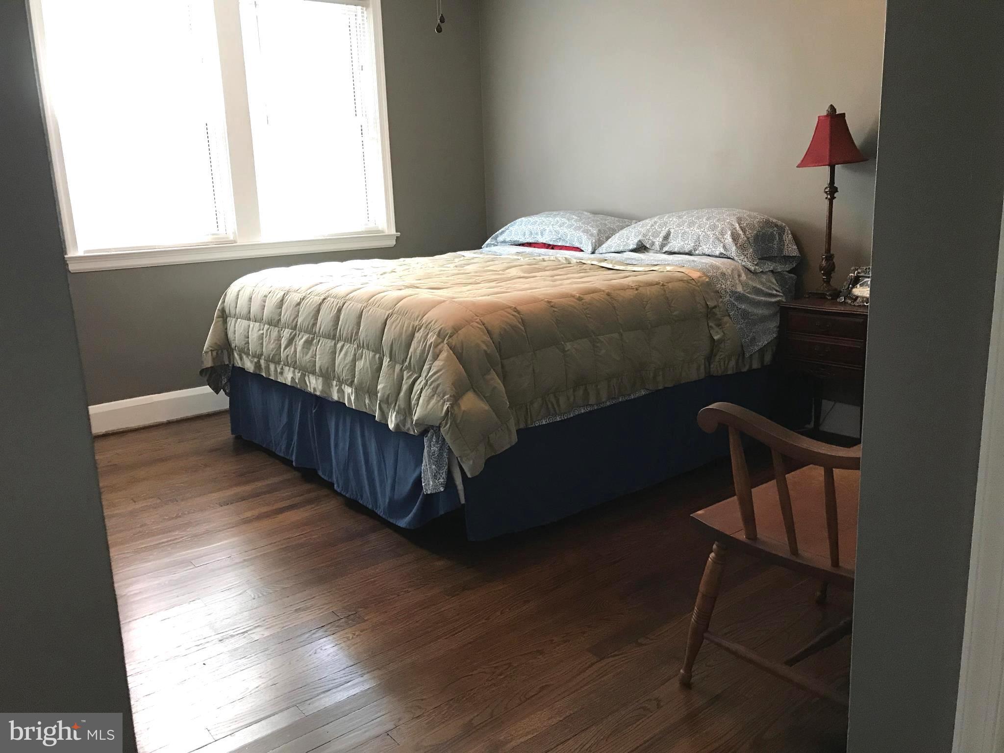223 Westowne Road Baltimore, MD 21229 - Photo 14 of 21 a bedroom with a bed window and wooden floor