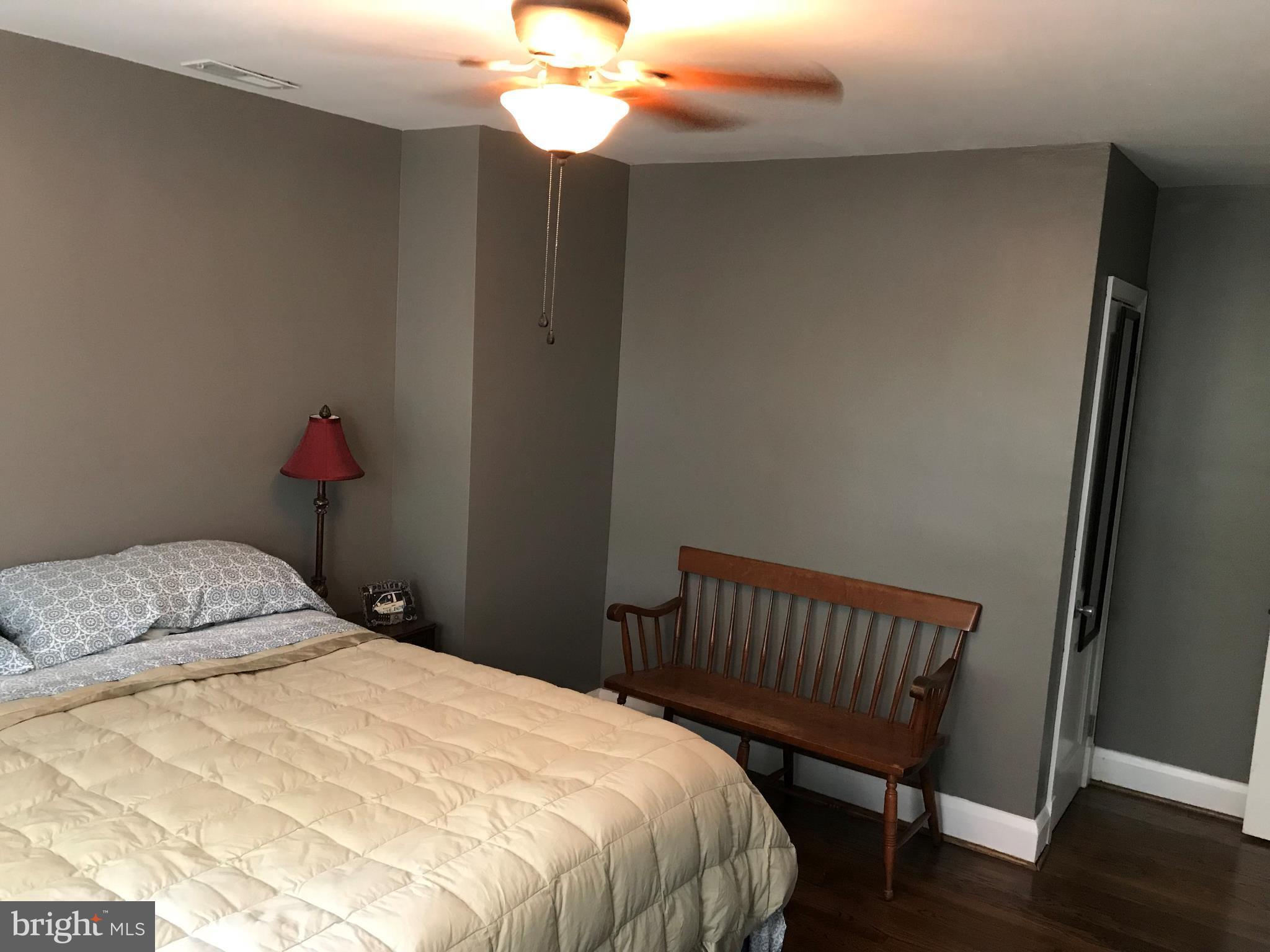 223 Westowne Road Baltimore, MD 21229 - Photo 15 of 21 a bedroom with a bed and wooden floor