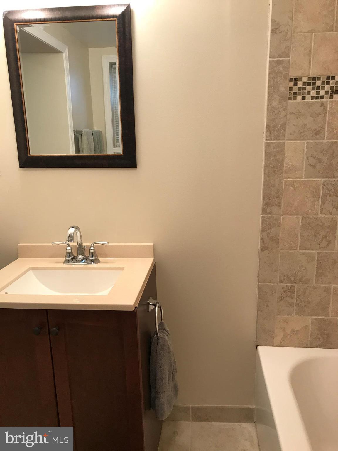 223 Westowne Road Baltimore, MD 21229 - Photo 19 of 21 a bathroom with a sink and a mirror