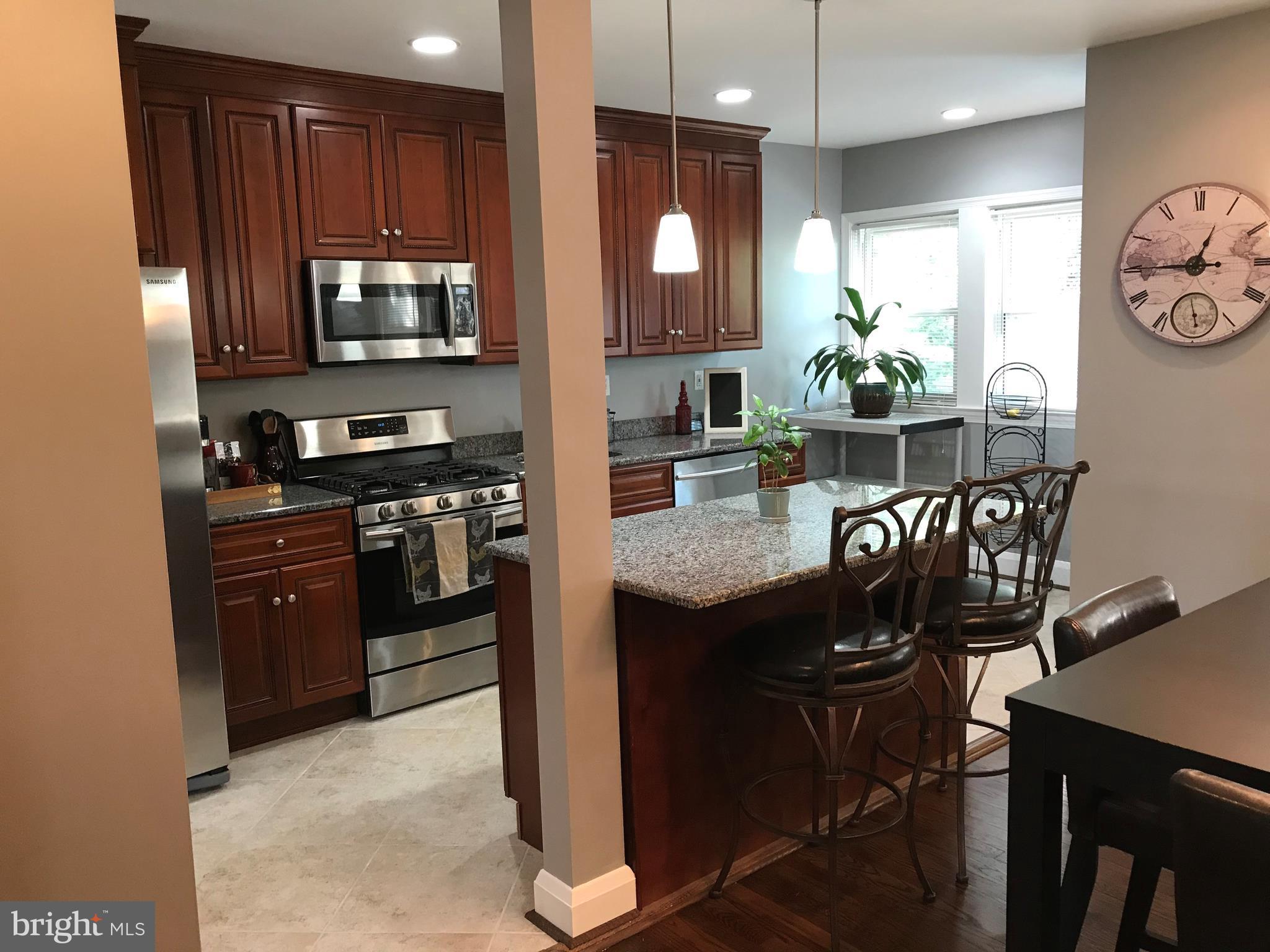 223 Westowne Road Baltimore, MD 21229 - Photo 7 of 21 a kitchen with granite countertop appliances dining table and chairs