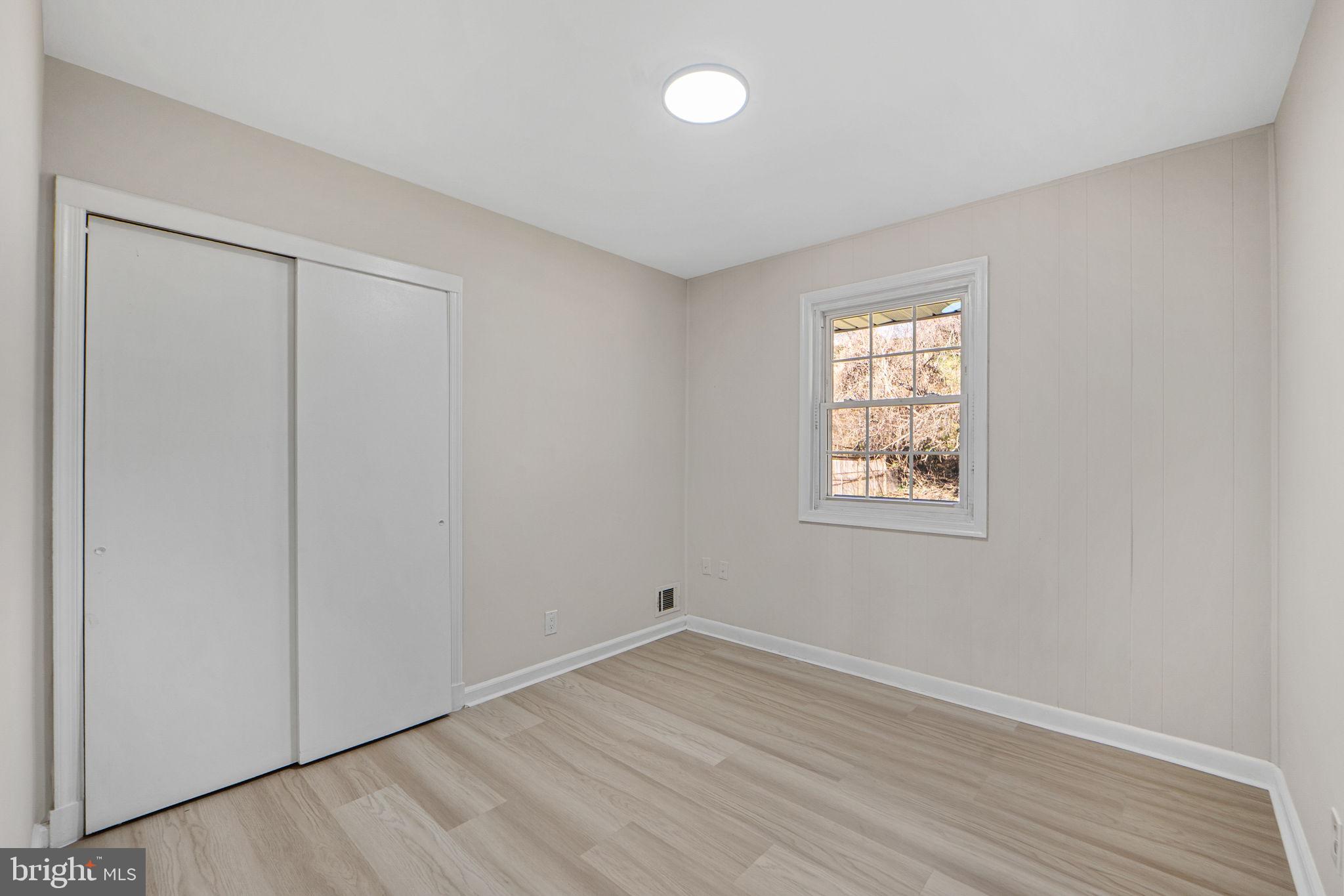 1513 Flora Lane Silver Spring, MD 20910 - Photo 24 of 49 an empty room with wooden floor and windows