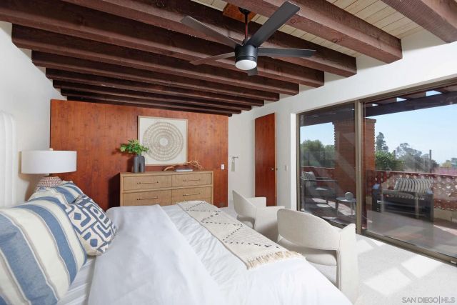 a bedroom with furniture and a large window