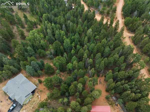 an aerial view of a house with yard