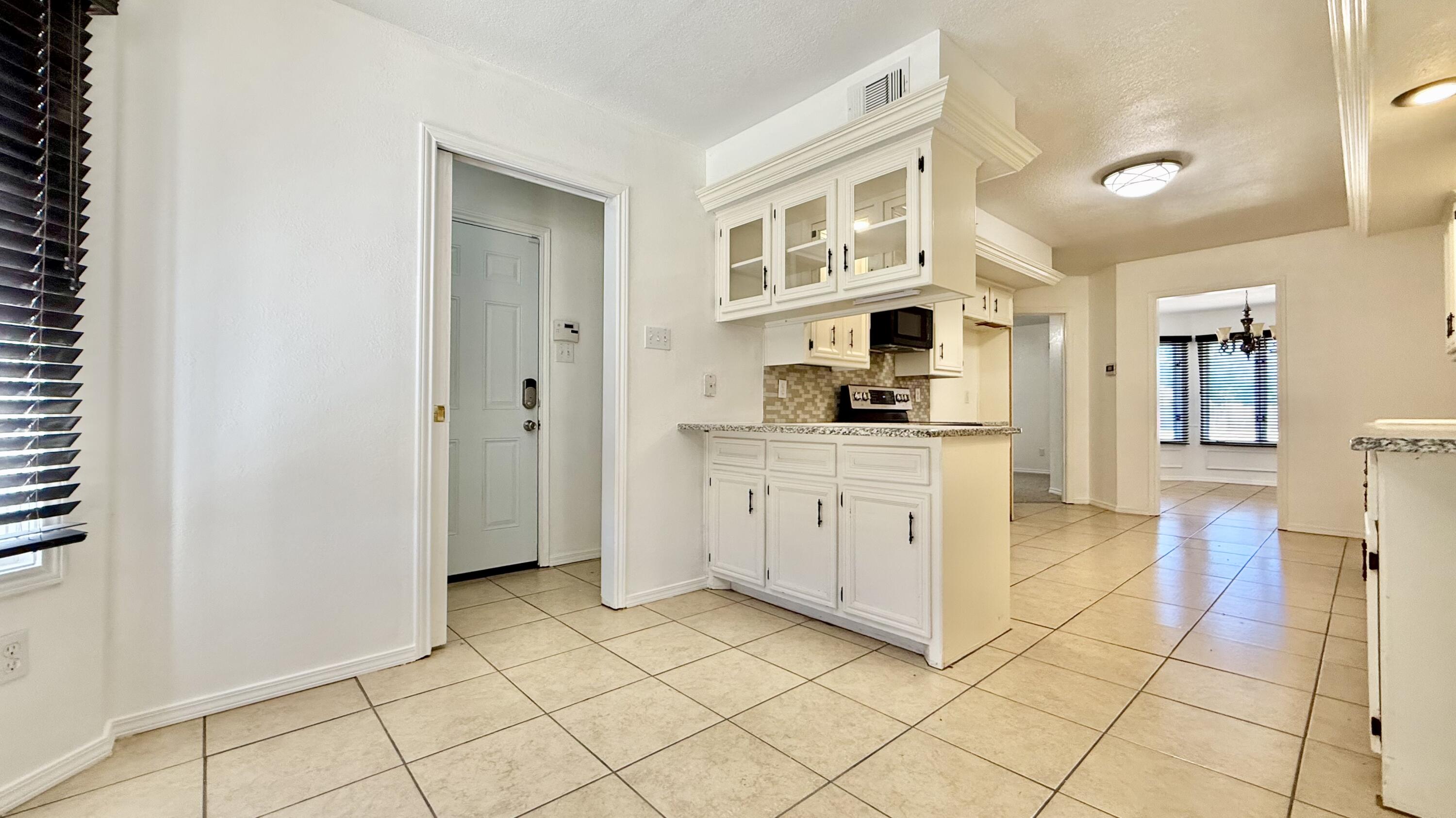 502 North Homestead Avenue Lubbock, TX 79416 - Photo 8 of 33 a kitchen with white cabinets and appliances