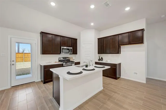 a kitchen with a sink stove and microwave