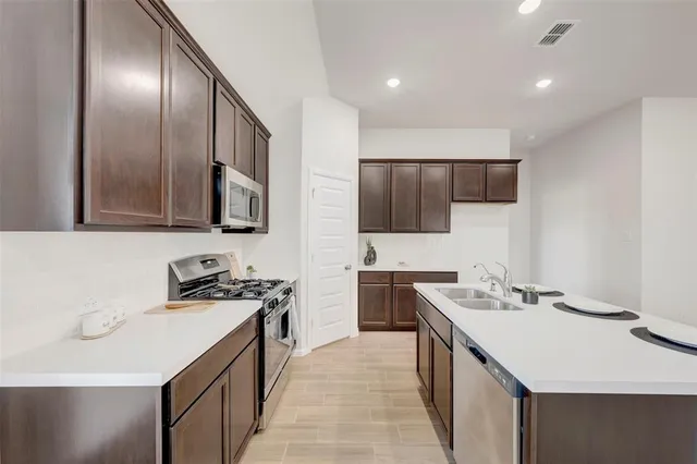 a kitchen with a sink stove and microwave