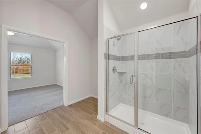 a bathroom with a glass shower door