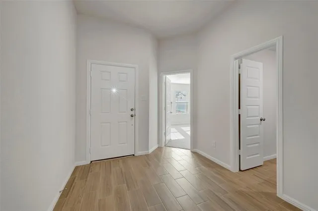 a view of a hallway with wooden floor