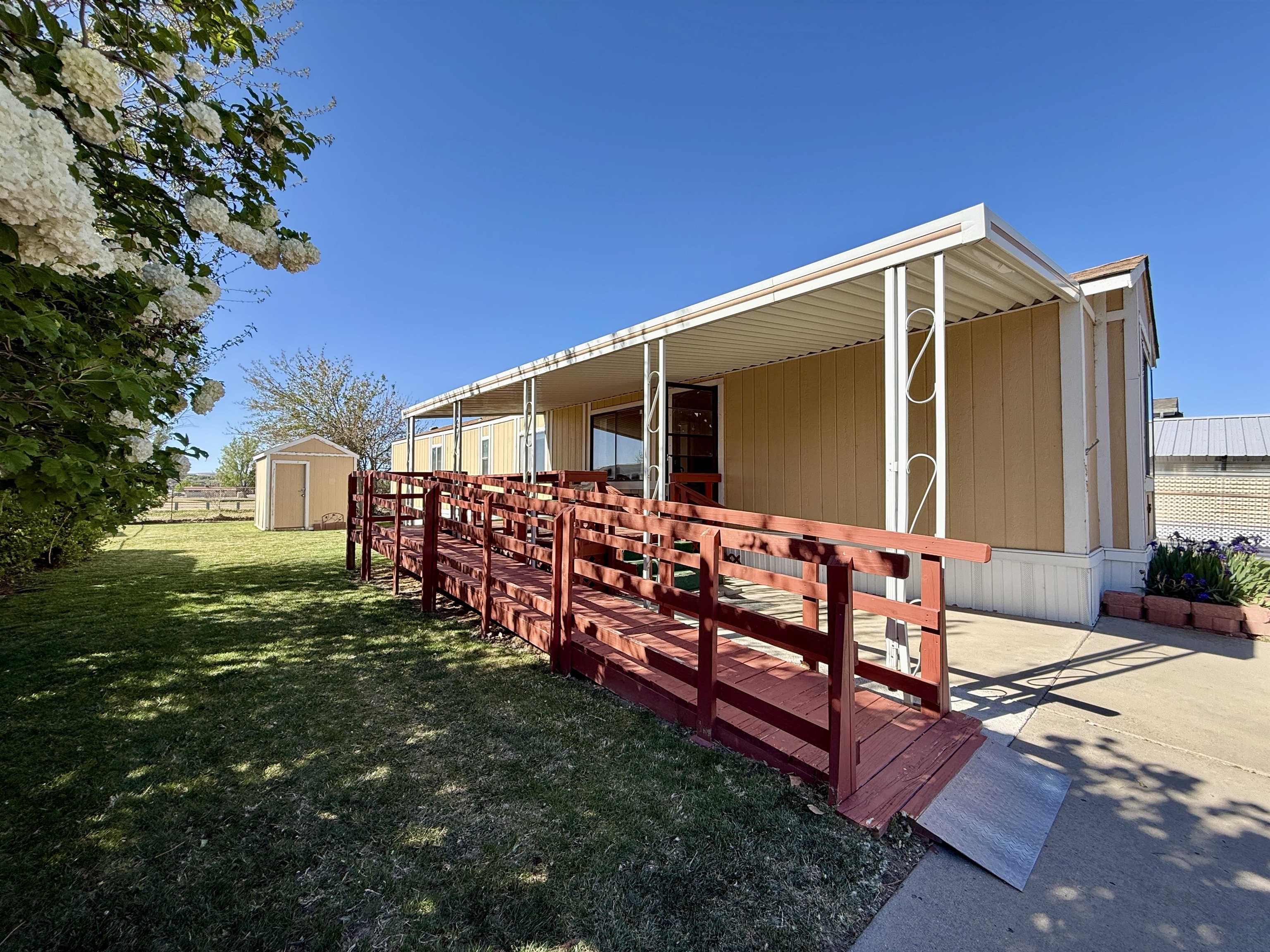 3251 E Road, Unit 33 Clifton, CO 81520 - Photo 5 of 28 a front view of house with yard outdoor seating and green space