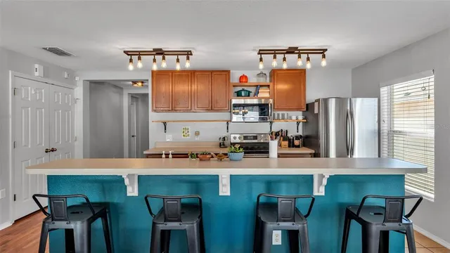 a kitchen with stainless steel appliances a sink stove and refrigerator