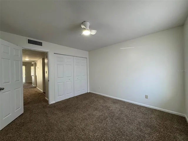 a bathroom with a toilet sink vanity and mirror