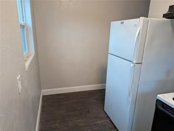 a white refrigerator freezer sitting next to a white cabinet