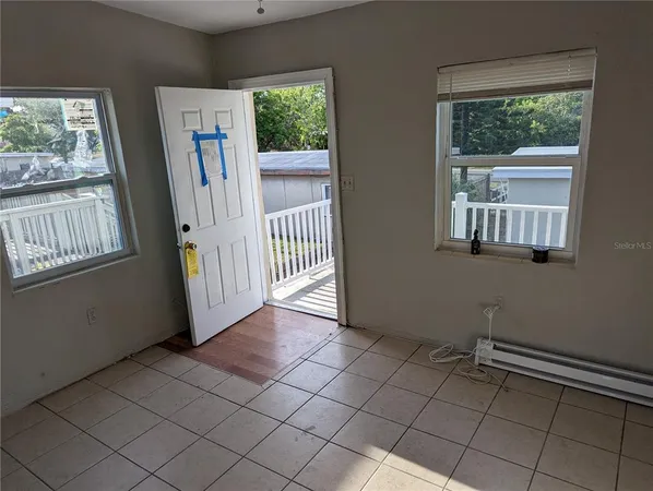 a view of a livingroom with an empty space and a window