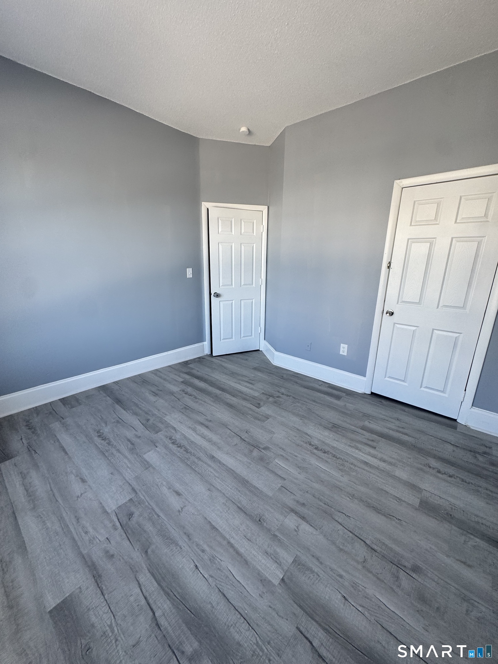 283 Wethersfield Avenue, Unit C2 Hartford, CT 06114 - Photo 6 of 7 a view of an empty room with wooden floor