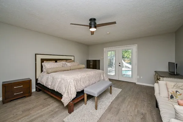 a bedroom with a bed and wooden floor