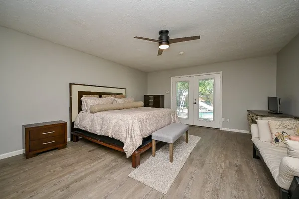 a bedroom with a bed and a tv