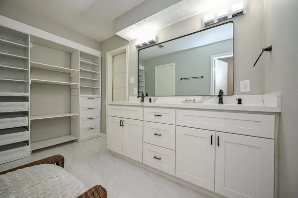 a bathroom with a double vanity sink mirror and