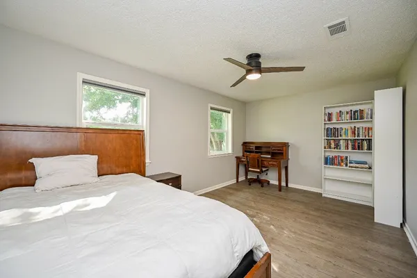 a bedroom with a bed and a book shelf