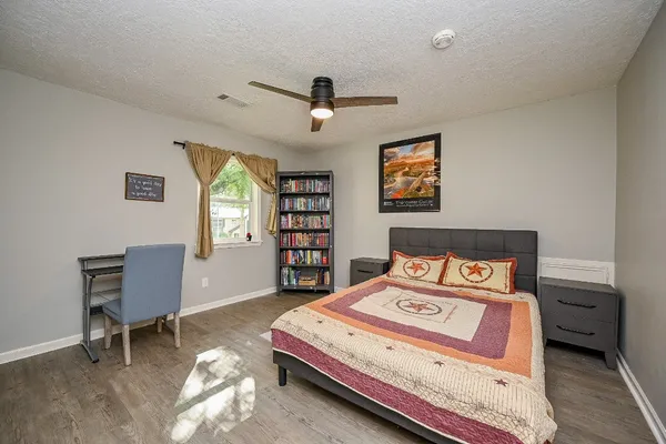a bedroom with a bed and a workspace