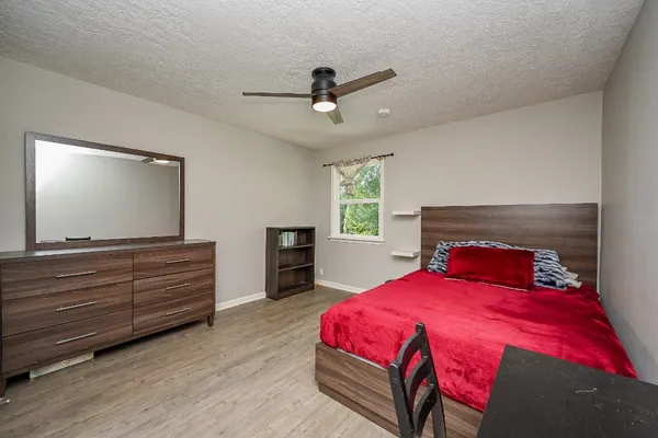 a bedroom with a bed and a flat screen tv